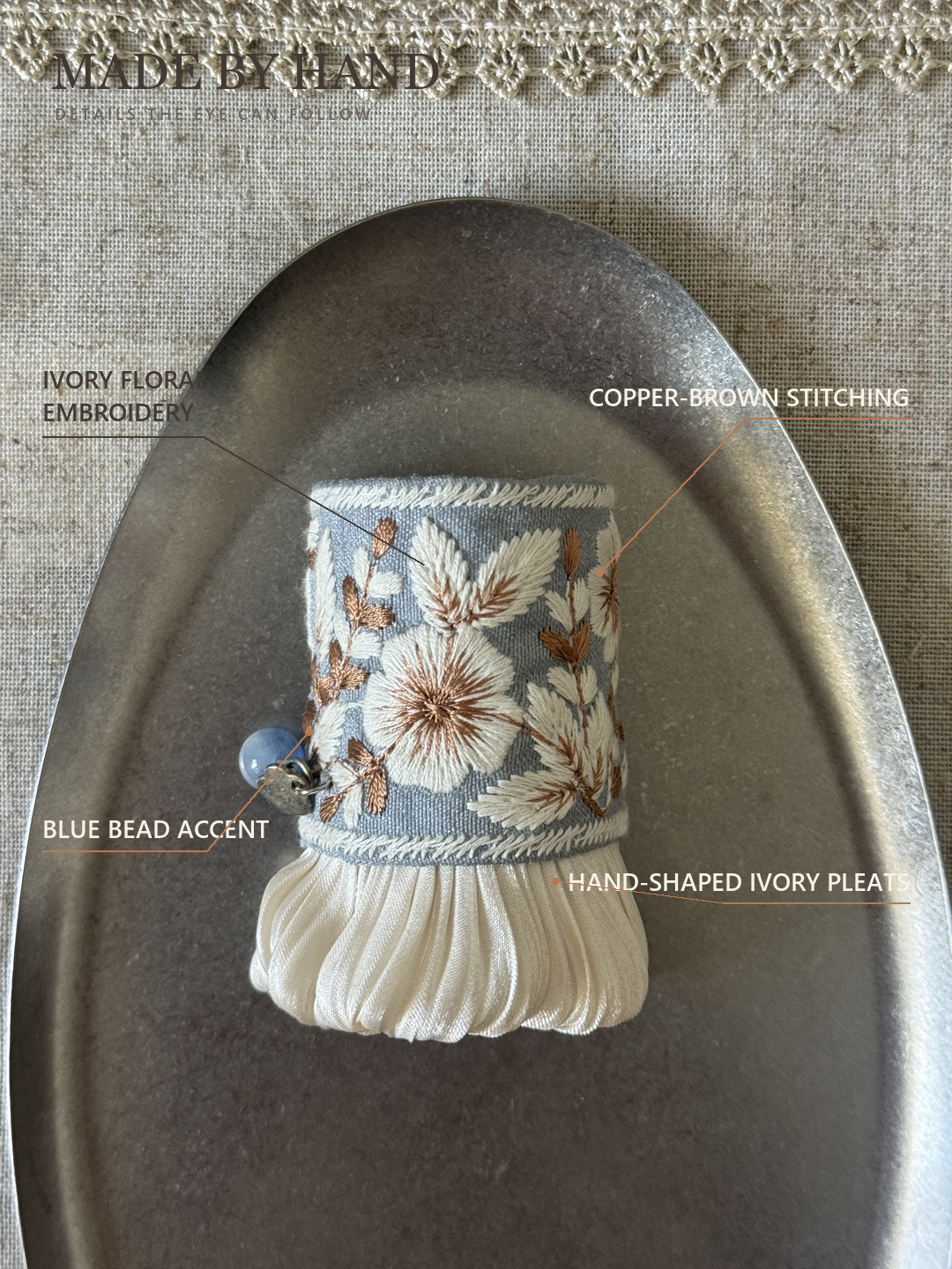 Fine-line craft detail guide to Bluebell Garden Pleat embroidery, stitched edging, pleats and bead accent