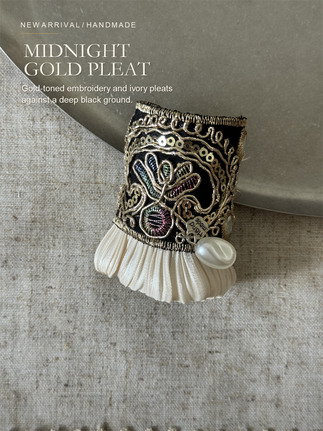 Midnight Gold Pleat editorial introduction with black and gold embroidered hair cuff