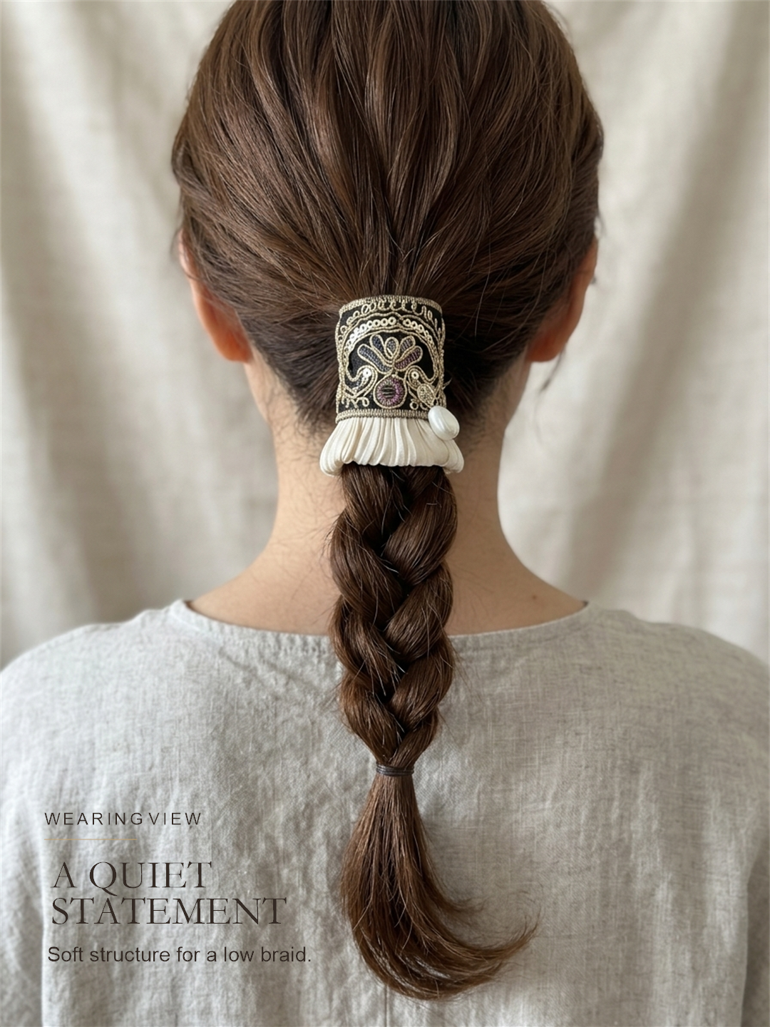 Midnight Gold Pleat worn as a softly structured accent on a braided ponytail