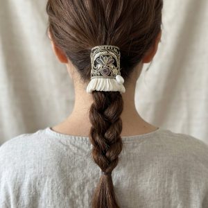 Midnight Gold Pleat black and gold embroidered hair cuff worn over a braided ponytail