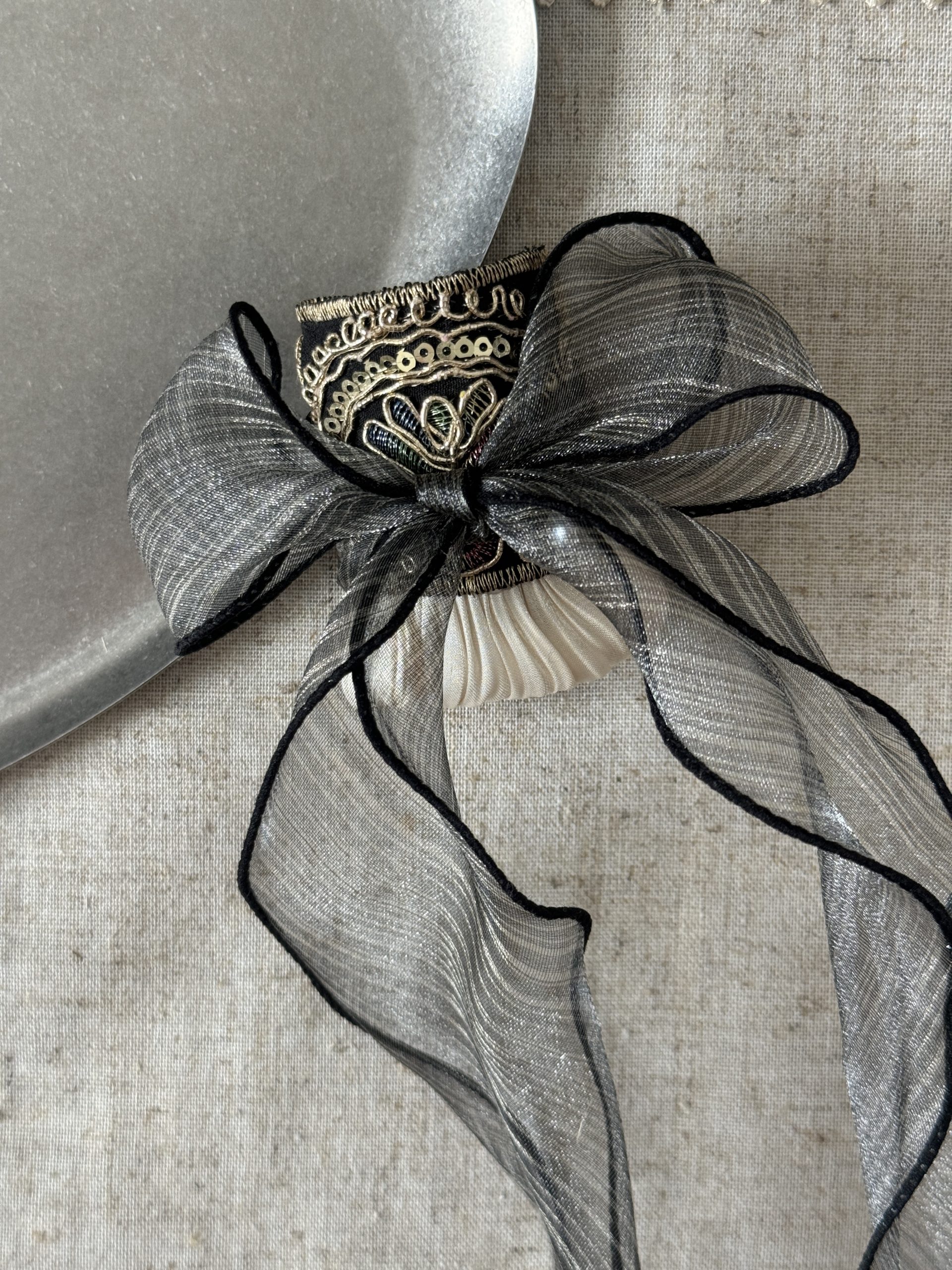 Midnight Gold Pleat hair cuff styled with sheer charcoal organza detail