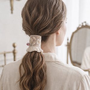 Rosewood Bloom Pleat worn on a low ponytail